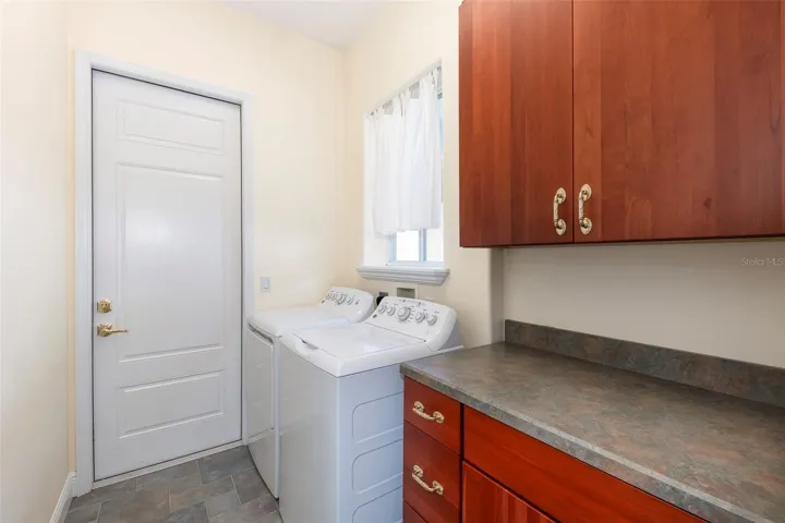 Inside laundry room with folding countertop. Plumbed underneath to add laundry sink if desired.
