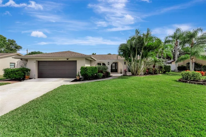 Spacious lot with lush landscaping and an inviting entryway.