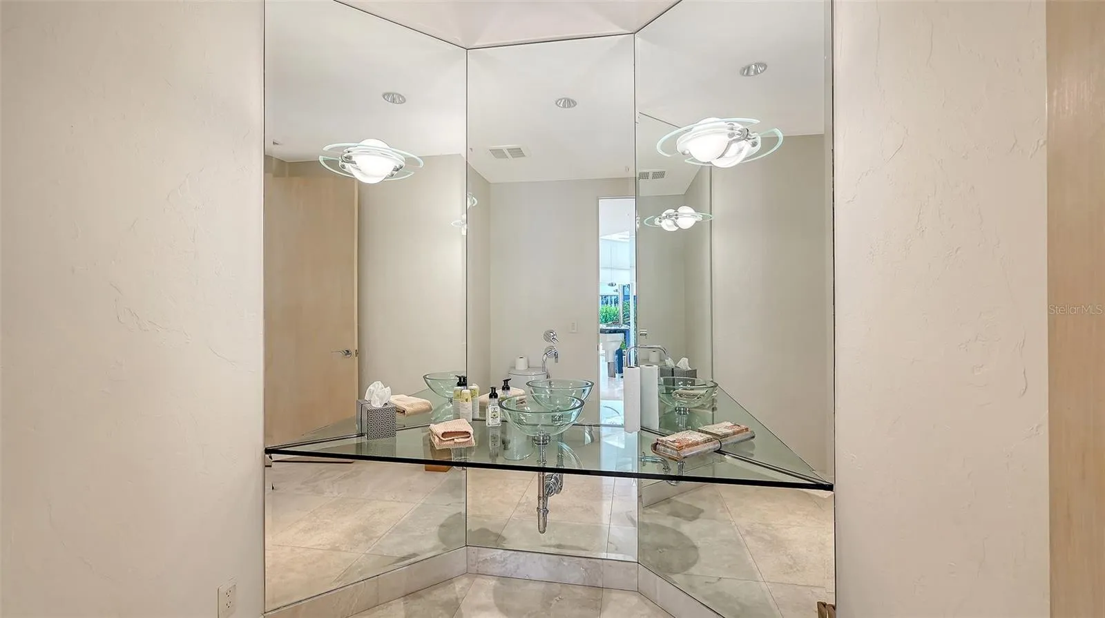 Half bathroom positioned just off the open-concept great room and circular kitchen