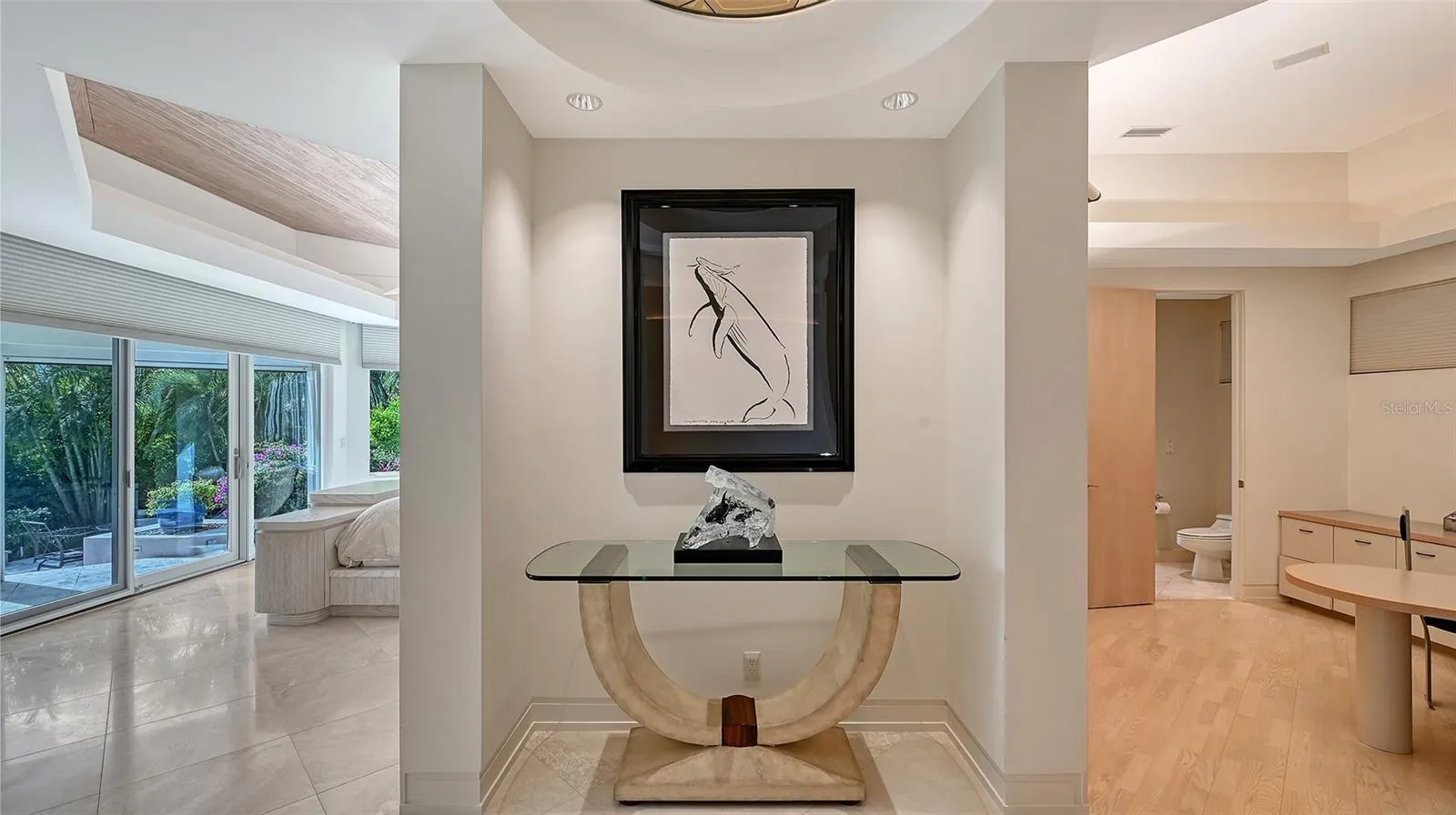 Dramatic entry to the primary suite creates an immediate sense of elegance and style