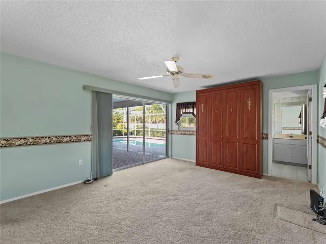 Primary bedroom with sliding door access to the lanai.