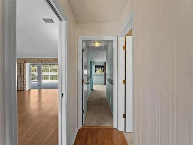 Hallway into first of two primary bedrooms.