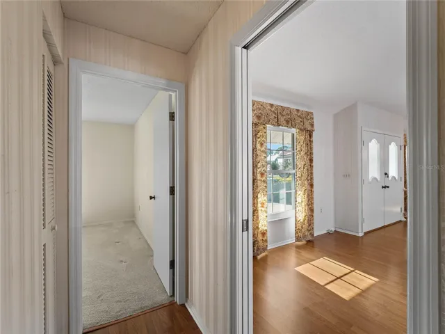Hallway into third bedroom with great room on the right.