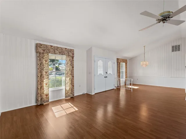 Entrance with double doors and dining room in the background.