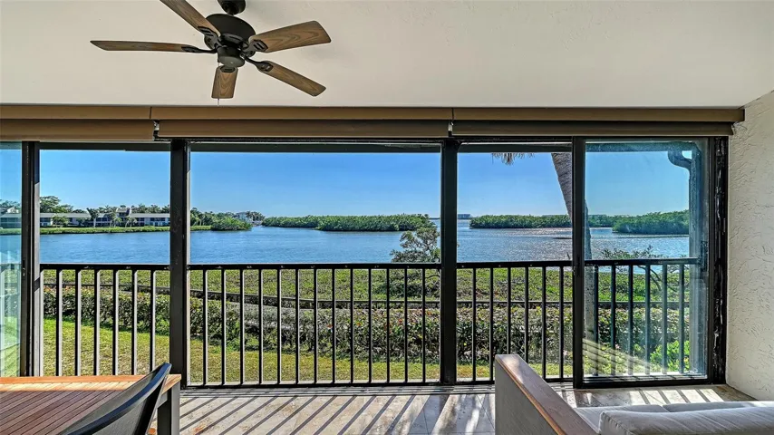 Solar shades on screened in lanai operated by a remote with sliding glass doors.