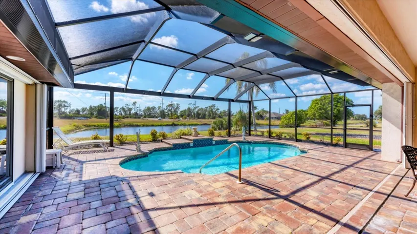 The oversized lanai is home to a sparkling pool surrounding by an attractive paver patio, all set to the backdrop of a tranquil canal.