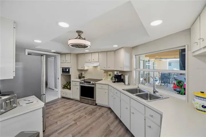 Chef Inspired Kitchen with Raised Recessed Lighting, Plenty of Cabinetry and Water Views from Sink