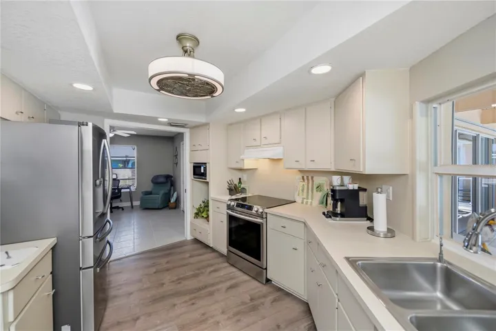 Chef Inspired Kitchen with Raised Recessed Lighting, Plenty of Cabinetry and Water Views from Sink