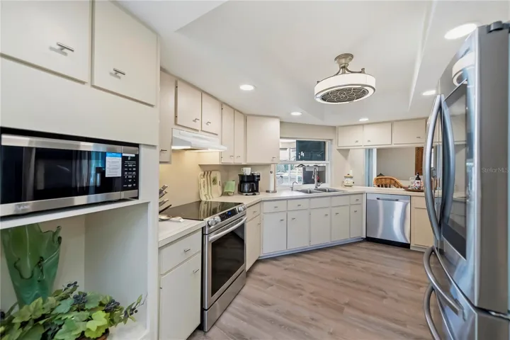 Chef Inspired Kitchen with Raised Recessed Lighting, Plenty of Cabinetry and Water Views from Sink