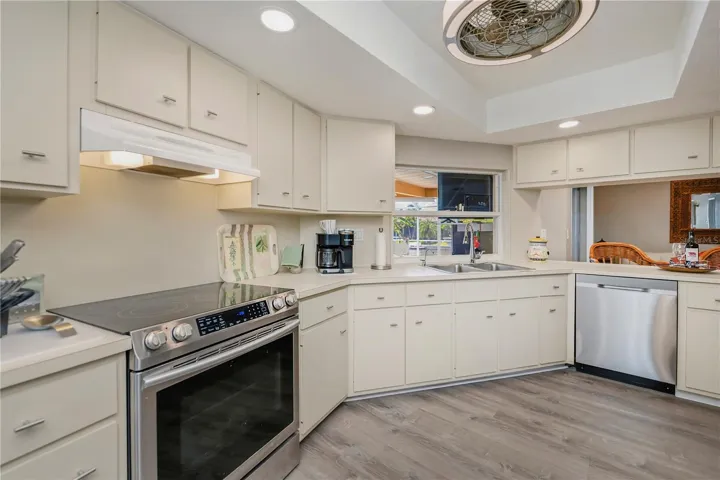 Chef Inspired Kitchen with Raised Recessed Lighting, Plenty of Cabinetry and Water Views from Sink