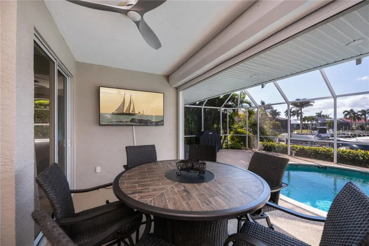 Covered Lanai with Waterviews, Tv Mounted on Wall, and In Ground Heated Pool plus Spa