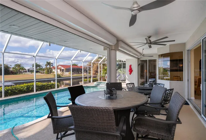 Covered Lanai with Waterviews, Tv Mounted on Wall, and In Ground Heated Pool plus Spa