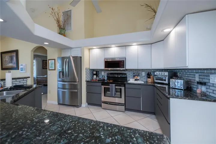 Updated Chef Worth Kitchen With Granite Tops, Recessed Lighting and Breakfast Bar