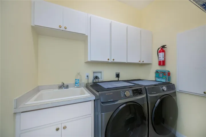 inside laundry with storage and maniblock plumbing