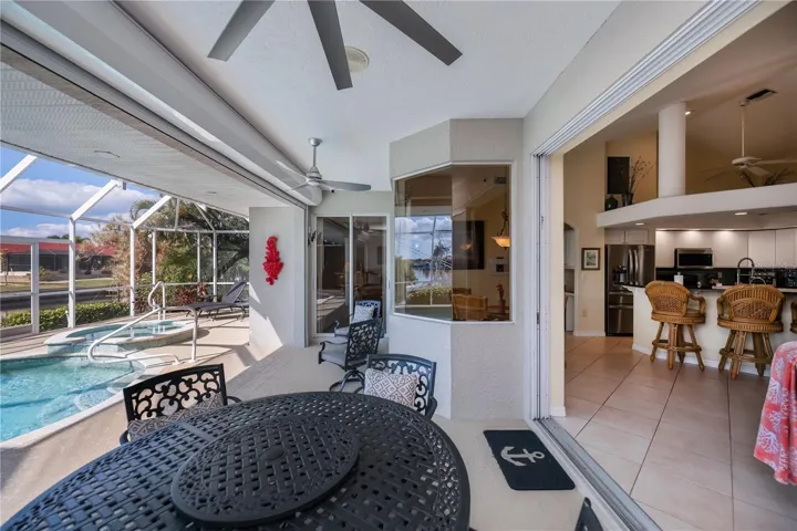 Covered Lanai with Waterviews, Tv Mounted on Wall, and In Ground Heated Pool plus Spa