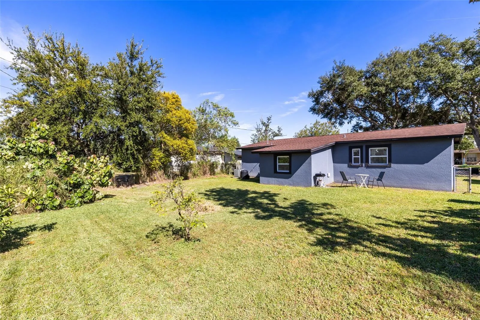 The large fenced backyard offers privacy, mature trees and plenty of space for outdoor living or future expansion.