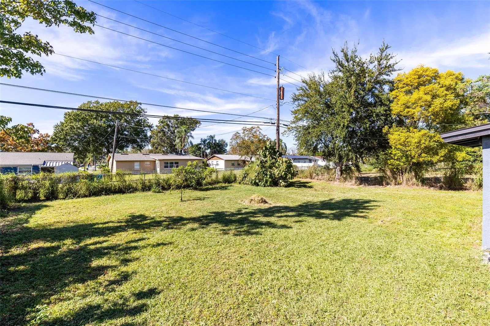 The large fenced backyard offers privacy, mature trees and plenty of space for outdoor living or future expansion.