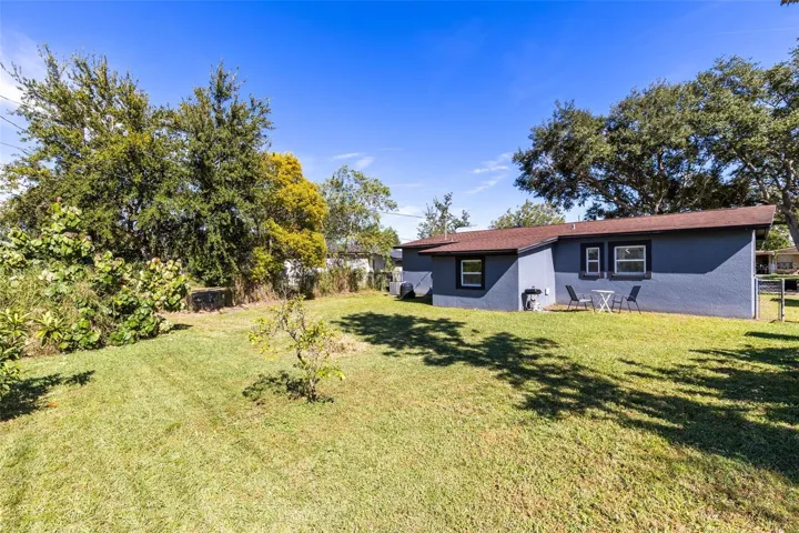 The large fenced backyard offers privacy, mature trees and plenty of space for outdoor living or future expansion.