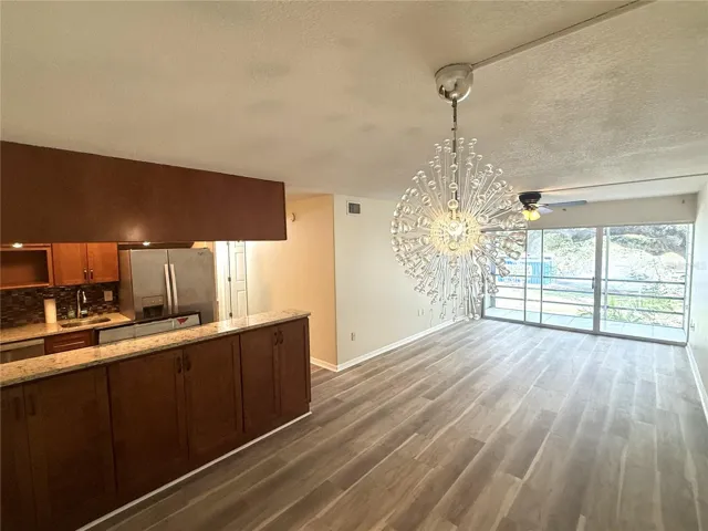 Living room with new textured ceilings, paint, wall paint and new vinyl plank flooring.