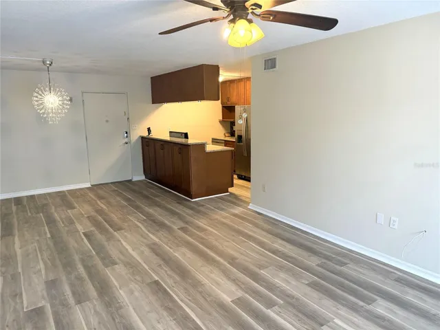View from living room back to dining area, front door and kitchen.