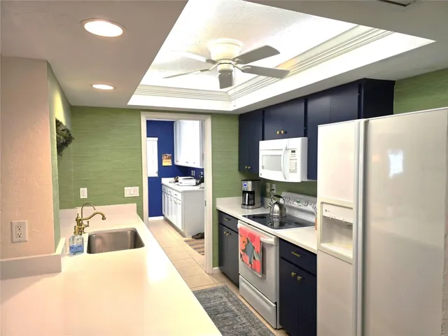Nicely updated with solid surface countertops, breakfast bar and access to utility room and laundry area