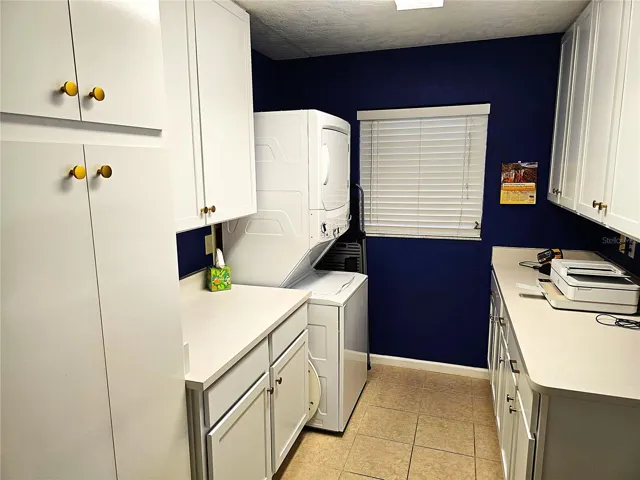 Utility / laundry room directly off the kitchen with plenty of cabinets for pantry use and additional storage