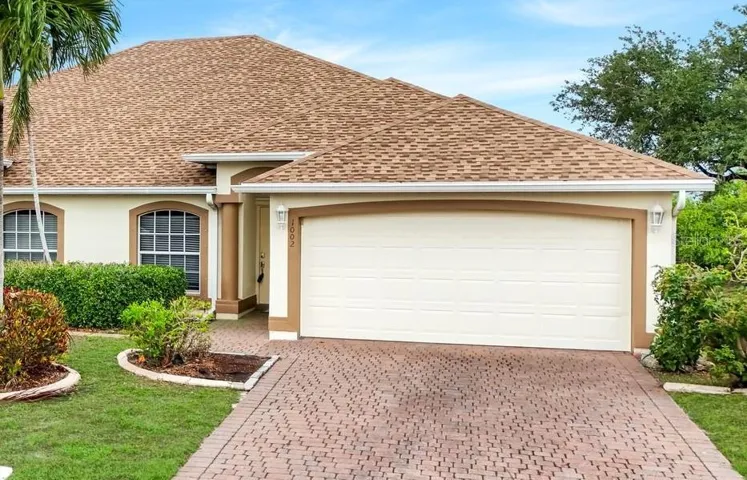 Front Entry to Unit, 2 car attached garage, paver driveway & sidewalk.