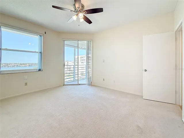Master bedroom with water view and doors to porch