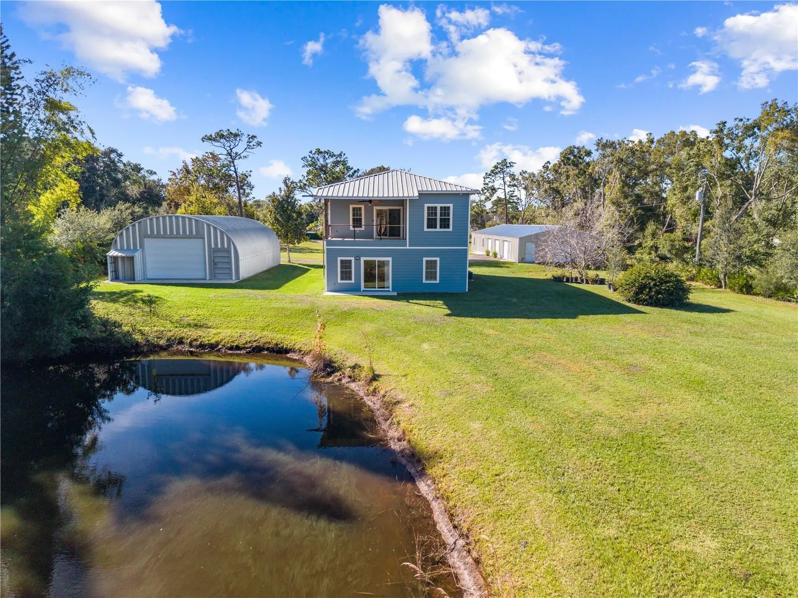 View of back of home from the pond