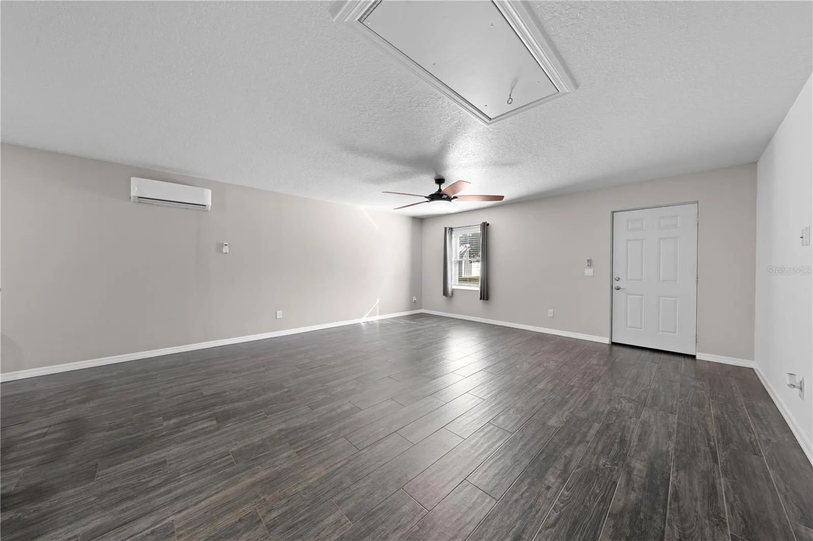 In-law suite view of living/dining rooms from kitchen. The door is the exterior front door.
