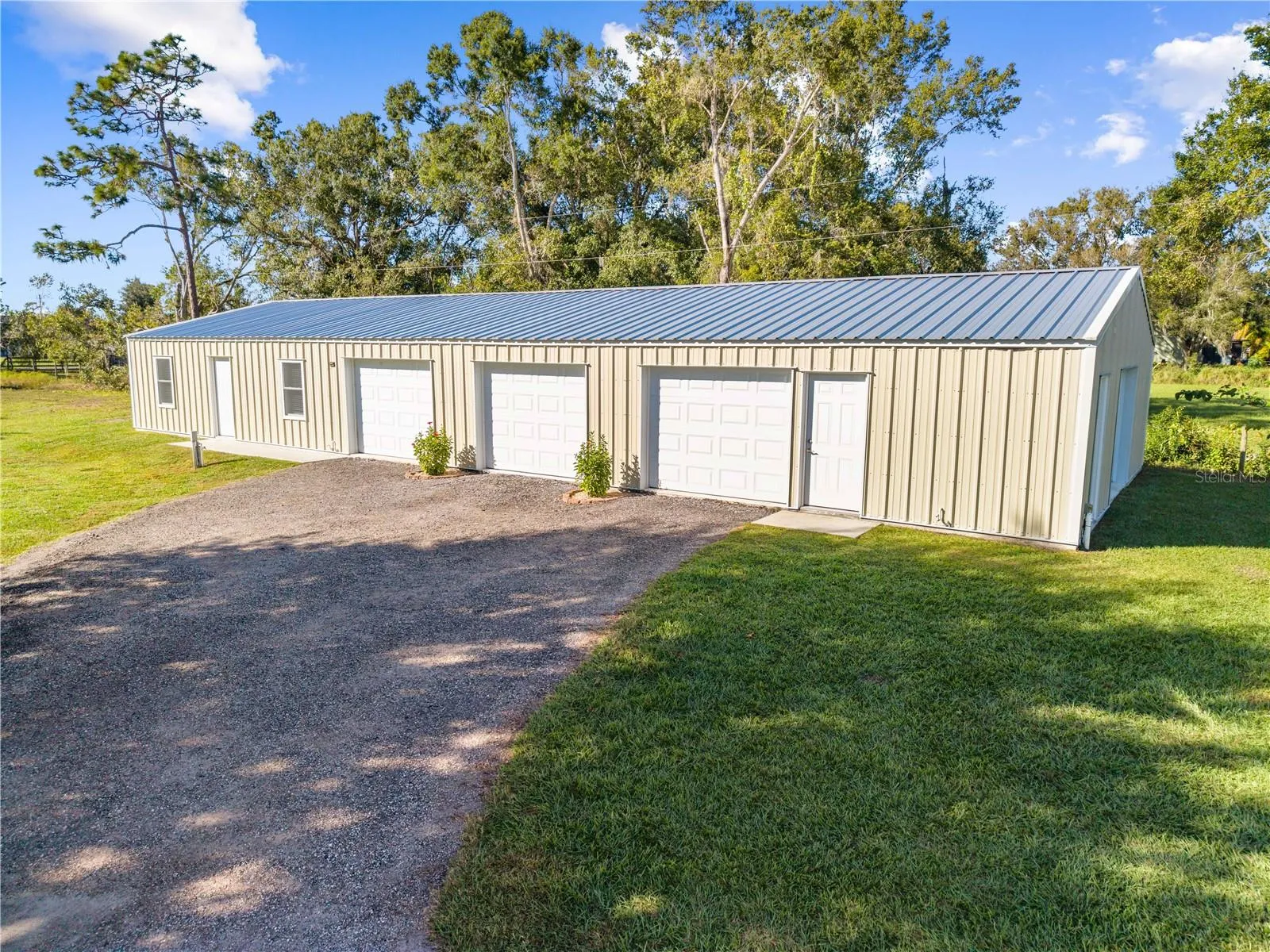 Air conditioned garage with full bathroom, attic space, water, electric, 3 roll up doors, 2 front one side and the in-law unit with one car garage.