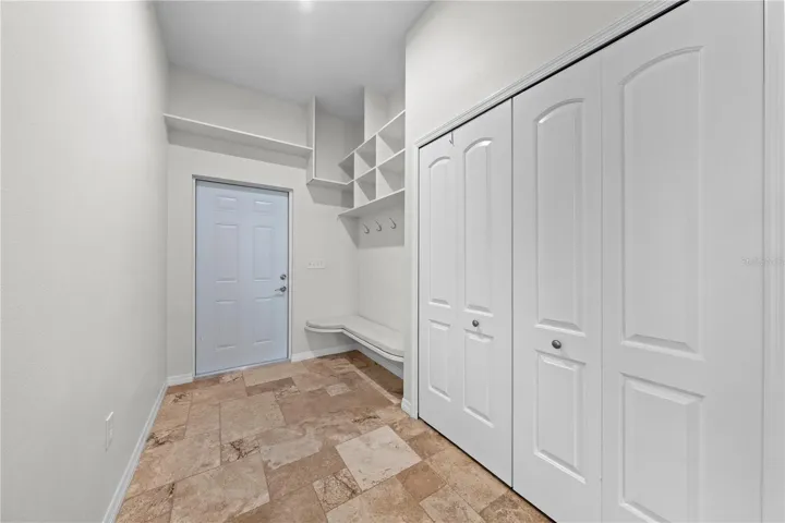 Main house upstairs mud room and laundry closet.  Through the door are the exterior stairs on the side of the home.