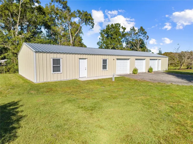 garage with bathroom, a/c, attic space, electric and water that is attached to the in-law suite. The in-law suite front door is between the windows and the one car garage private entrance is the 1st bay.