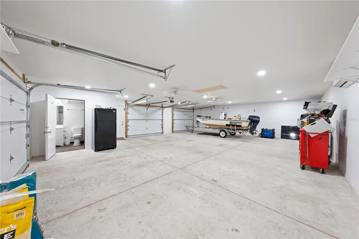 Inside of garage with bathroom, a/c, attic space, electric and water that is attached to the in-law suite photo 3