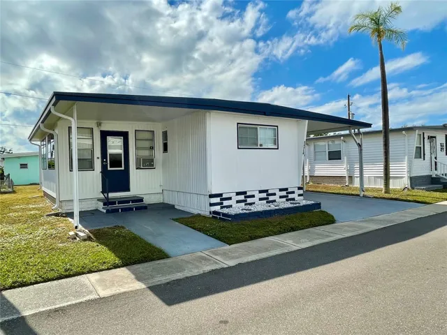 Front - Roof is coated every 2 years! Home has recently been painted. Covered front patio