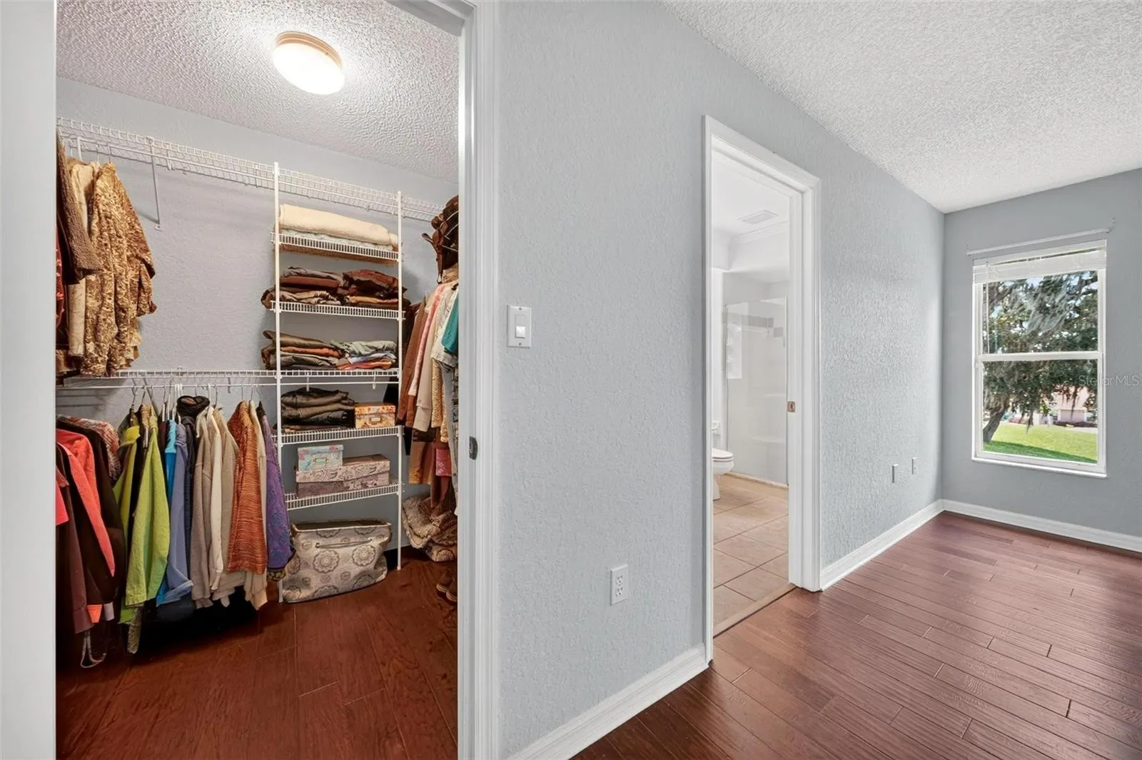 Primary bedroom walk in closet