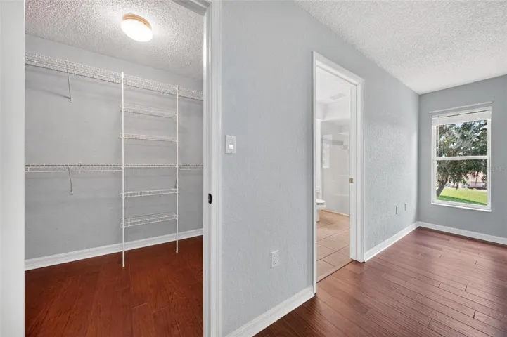 Primary bedroom walk in closet