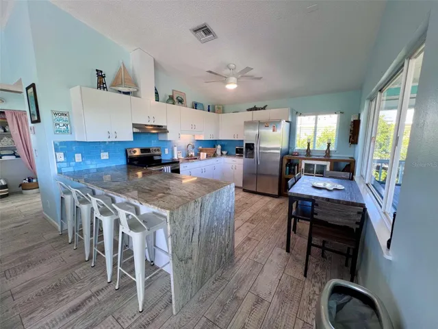 Kitchen with waterfall granite countertops