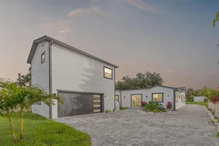 3101 Pickfair Street rear view showcases both buildings on the property along with an oversized parking area that can potentially accommodate up to 10 cars, offering outstanding convenience for residents, guests, or renters.