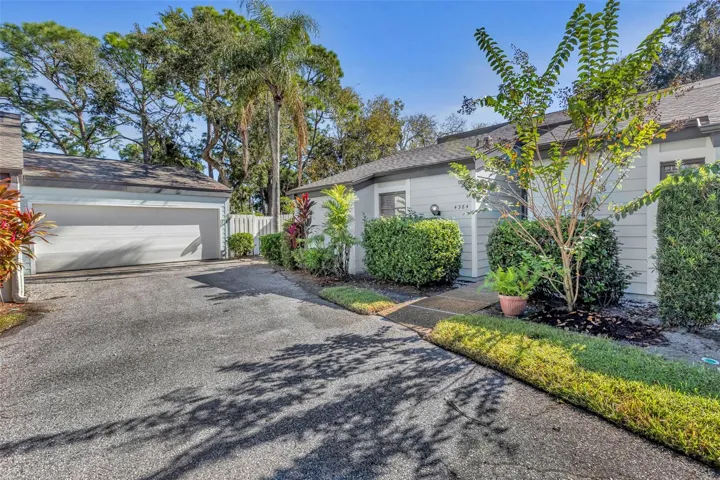 View of home and large two car garage with courtyard