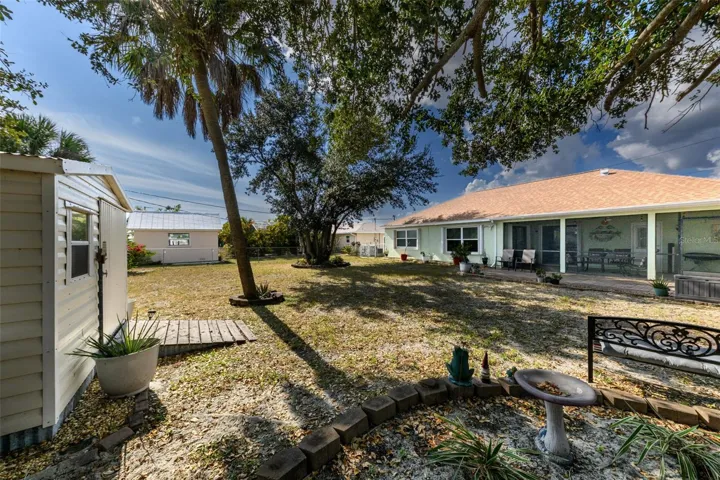 A spacious backyard with a storage unit