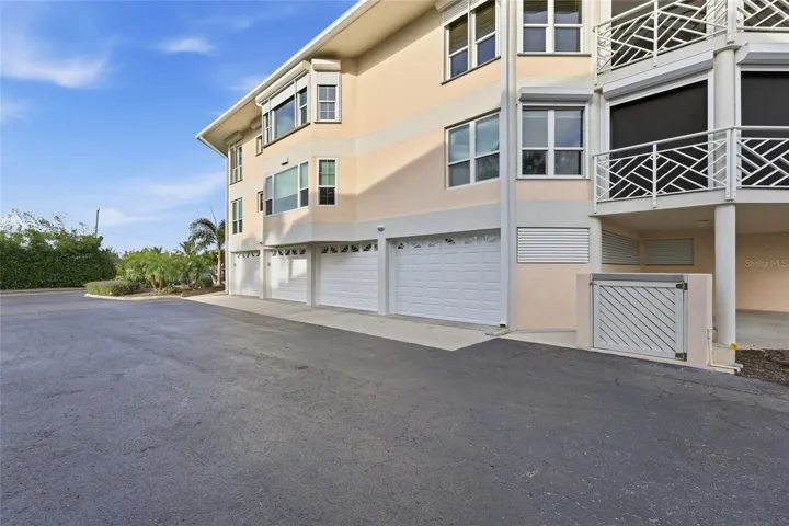 New garage door - far right in photo.  This two-car tandem lane has an adjacent alcove the current owners use to store their golf cart for easy access. Boats/trailers are permitted to be parked/stored in these garages.