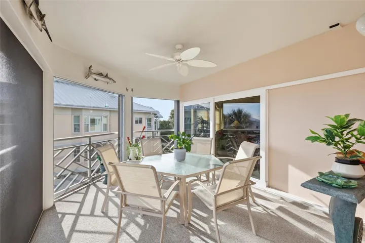 Gorgeous screened rear lanai with custom designed indoor/outdoor carpet, exterior electric hurricane shutters with the added protection of hurricane rated impact glass sliding doors to the living room and primary suite.