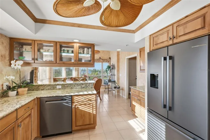 Renovated kitchen with wood cabinetry, granite countertops, and 2024 black stainless steel Bosch appliances (fingerprint resistant). Overlooking the breakfast nook.