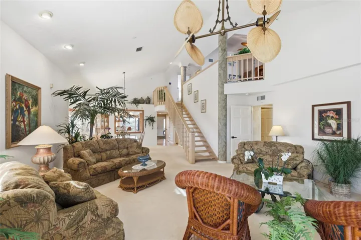 Living Room with view of stairwell to second floor loft that includes another living space, office area, and 2nd guest bedroom/bathroom.