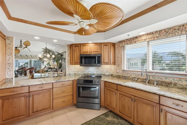 Renovated kitchen with wood cabinetry, granite countertops, and 2024 black stainless steel Bosch appliances (fingerprint resistant).