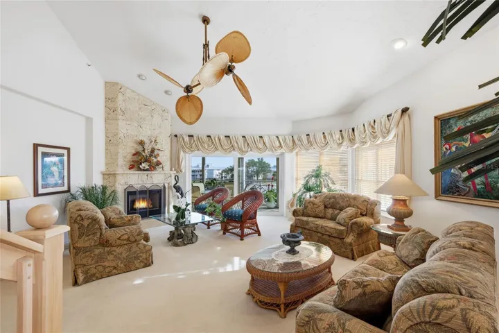Living Room with coral-clad electric hologram fireplace; also functions as a heating unit. Gorgeous sliders to rear porch with stunning water views!