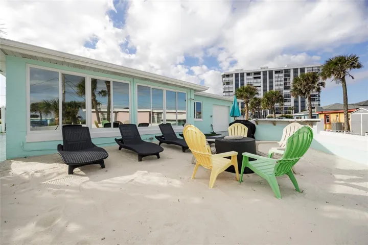 Back yard with beach sand, beach view, grill, and bar top