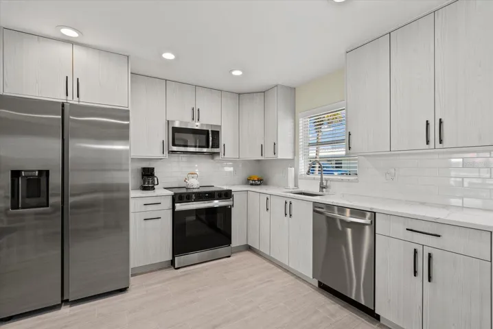 Beautifully renovated kitchen. European imported cabinets, quartz counters and new appliances.