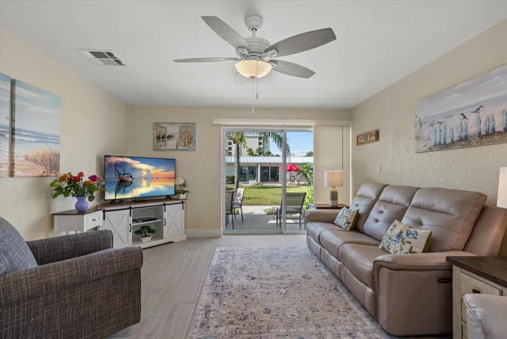 Living room features all brand new furniture and new window treatments. Out back you will find tropical landscapes. You are located in the middle of 2 resort style sparkling pools.